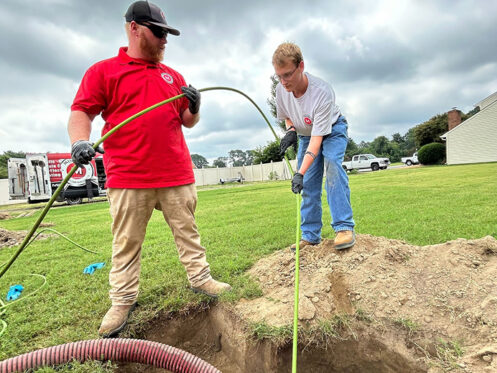 Miller's services team members repairing a septic pump