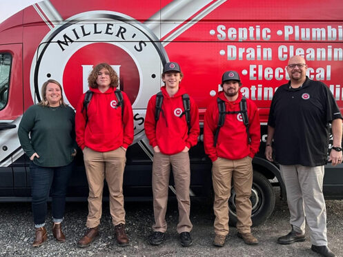 Miller's Services team members in front of a van