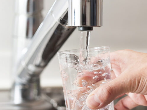 Clean tap water being poured into a cup