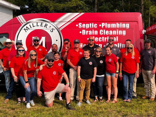 Miller's Services team members in front of a van