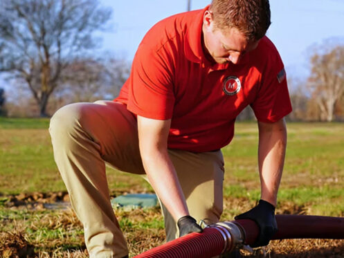 Miller's services team member repairing a septic pump